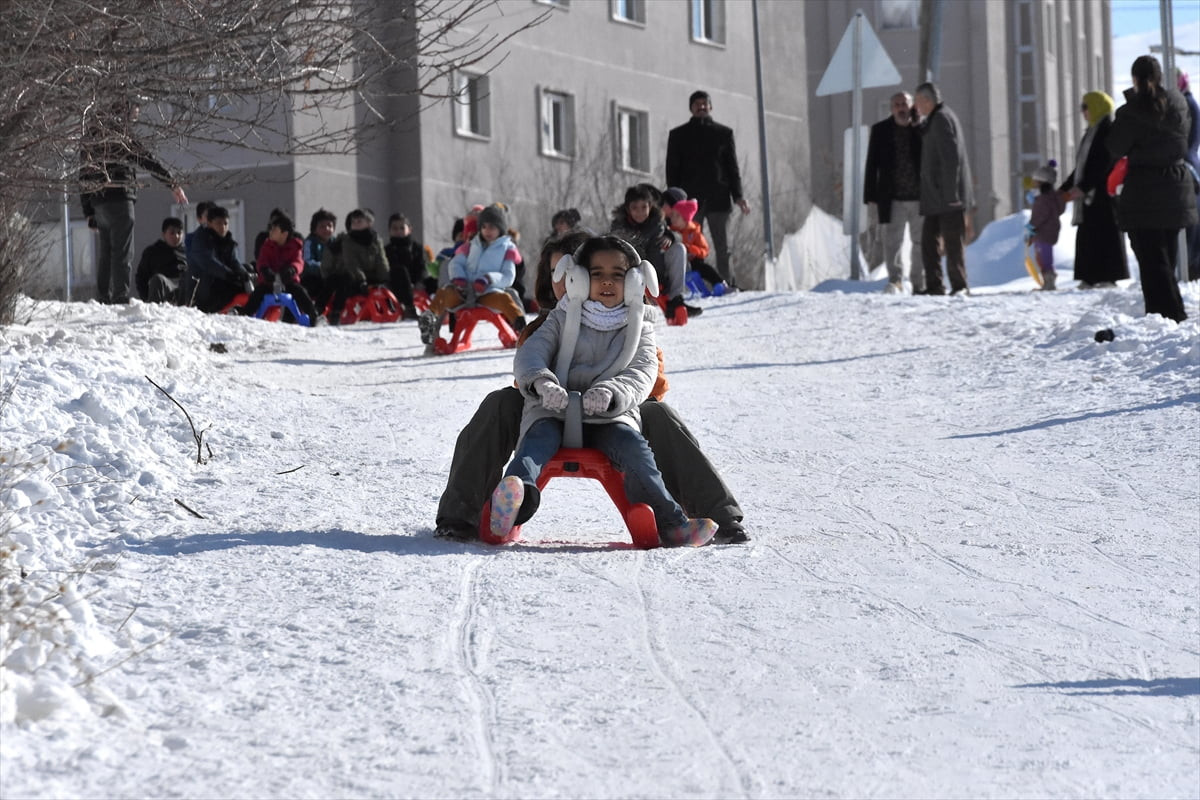 Van'ın Edremit ilçesinde karın ardından güneşli havayı fırsat bilen çocuklar, kayak pistine...